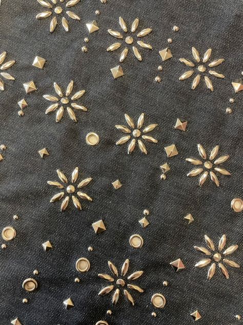 Olive-colored fabric with metallic flower motifs.