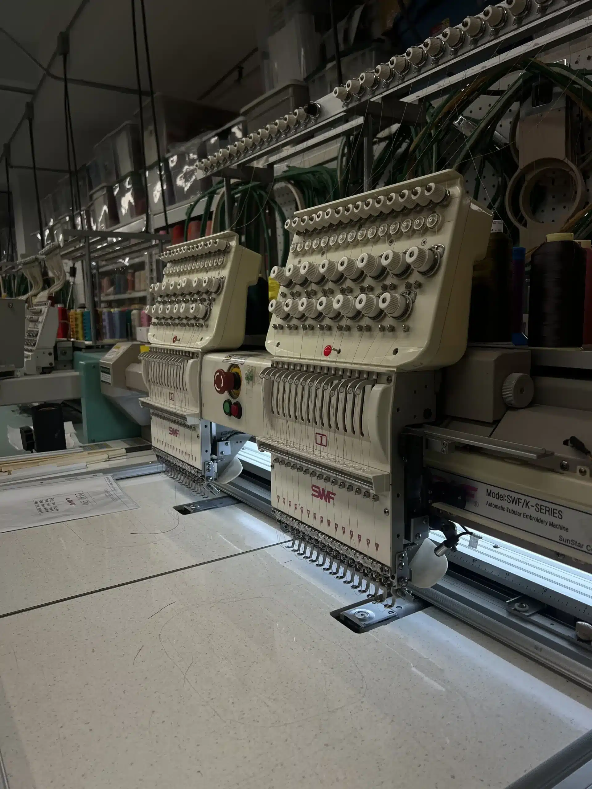Close-up view of an SWF multi-needle embroidery machine setup at New York Embroidery Studio