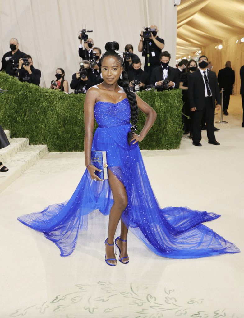 Amanda Gorman wearing a strapless cobalt blue gown with a thigh-high slit, long train, and matching heels at the Met Gala.