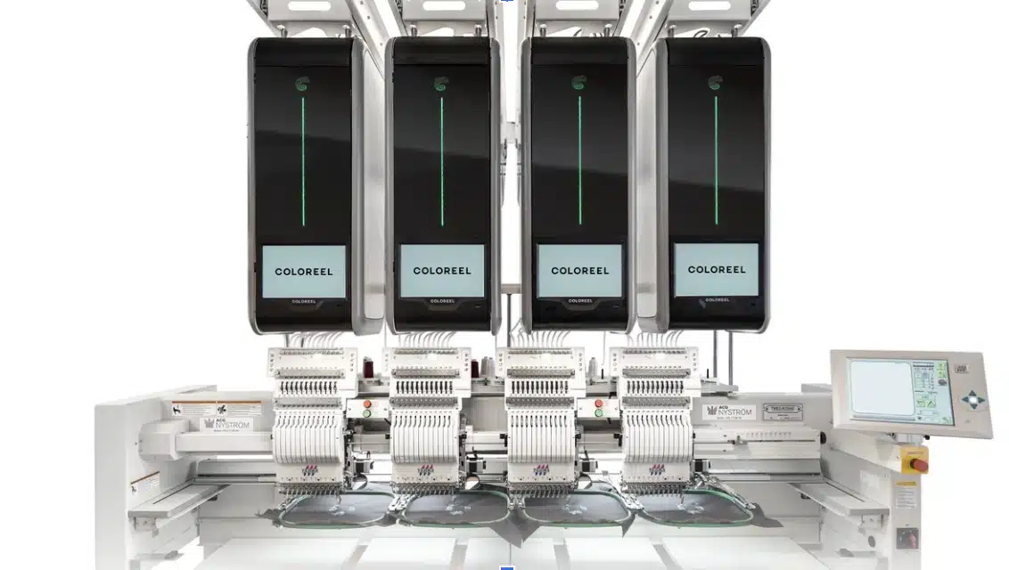 Front view of a high-tech Coloreel embroidery machine with four synchronized heads and digital thread coloring units above