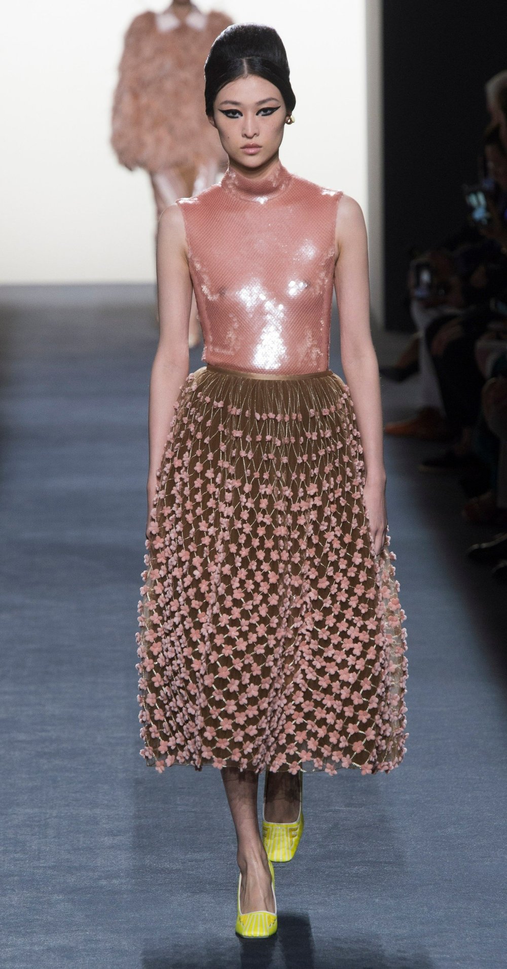 A mid-length skirt in a light brown shade, featuring skin-toned or nude pink dots, paired with a latex-like bodysuit that perfectly complements the skirt's details.