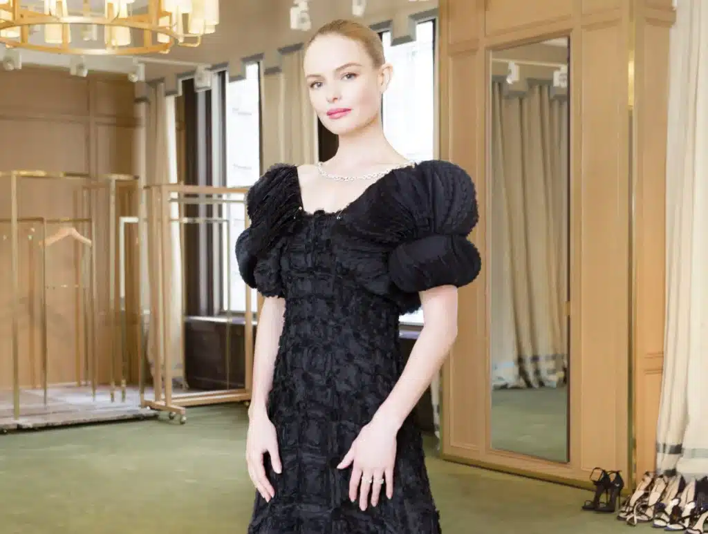 Kate Bosworth at the Met Gala wearing a dramatic black dress with puffed sleeves and detailed texture.